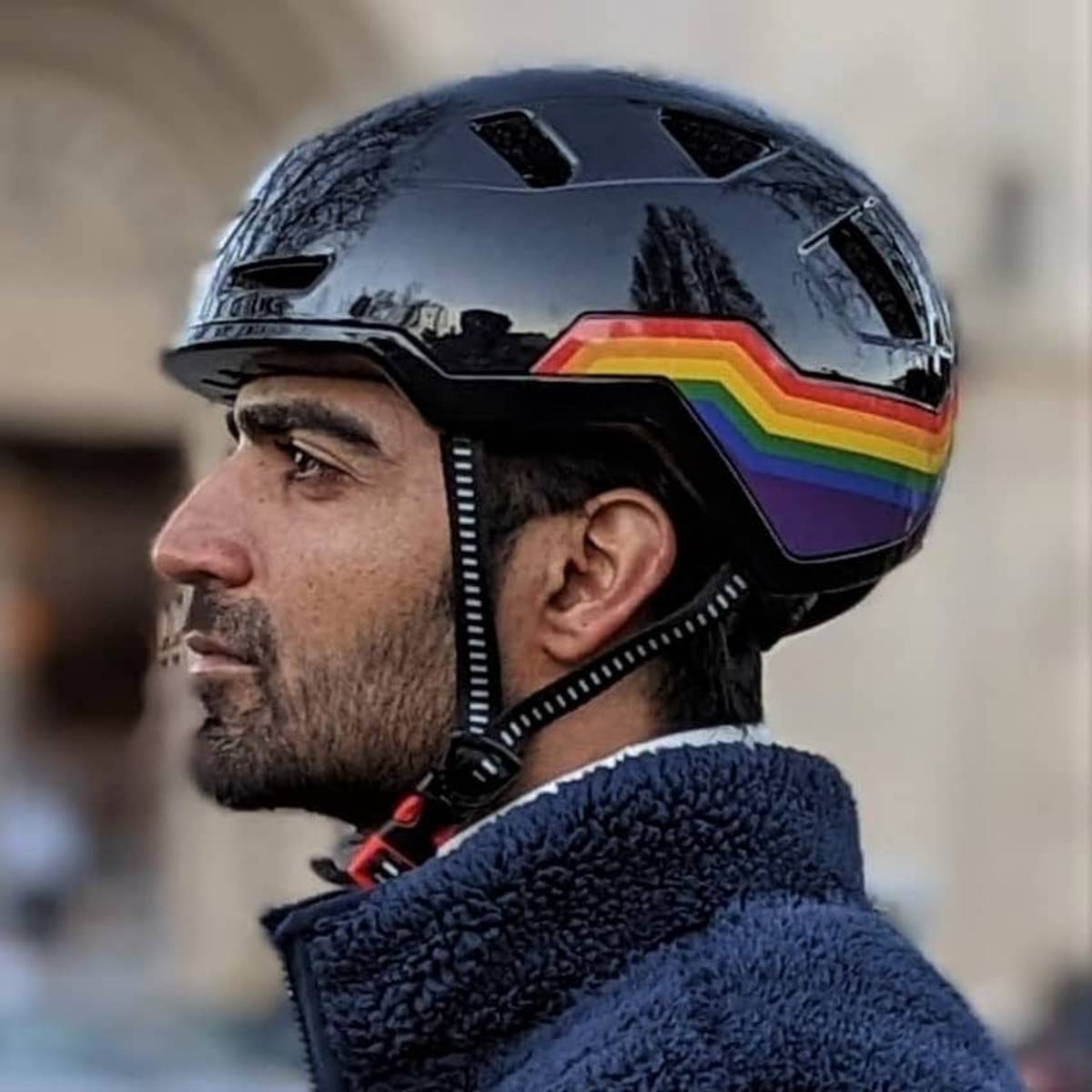 Person wearing XNITO helmet with rainbow design