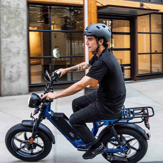 Person riding e-bike wearing Urbanite helmet