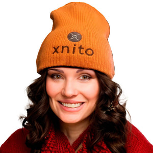 Woman smiling in orange Xnito beanie with logo