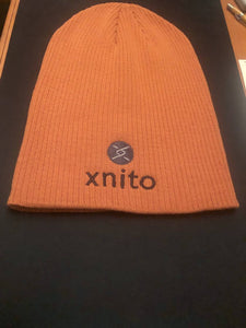 Orange Xnito beanie with logo on dark background