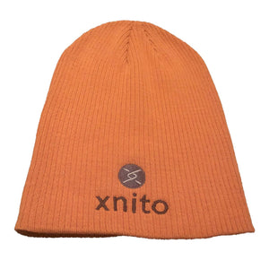 Orange Xnito beanie with logo on flat surface